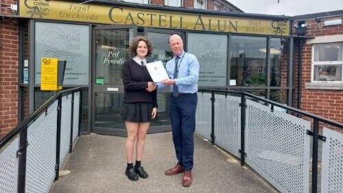 A photo of Mr Paul Edwards presenting a ‘Highly Commended’ award to Alex for their translations in both French and Spanish in the Anthea Bell Translation competition