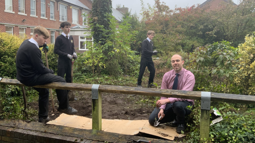 A photograph of students planting strawberries as part of their Year 11 Applied Science circa October 2024