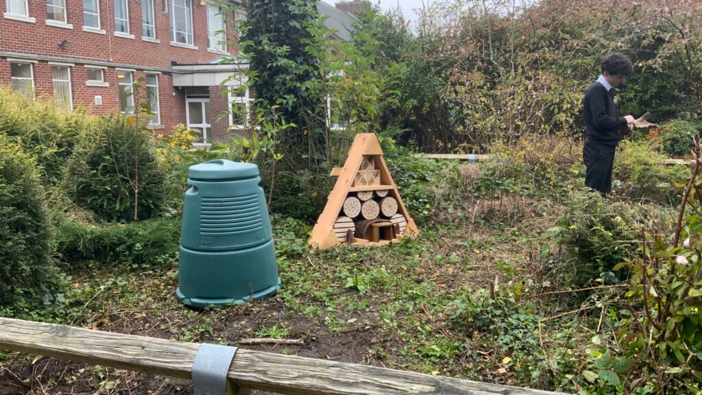 A photograph of students working on the School Garden Project in the Quad, circa November 2024