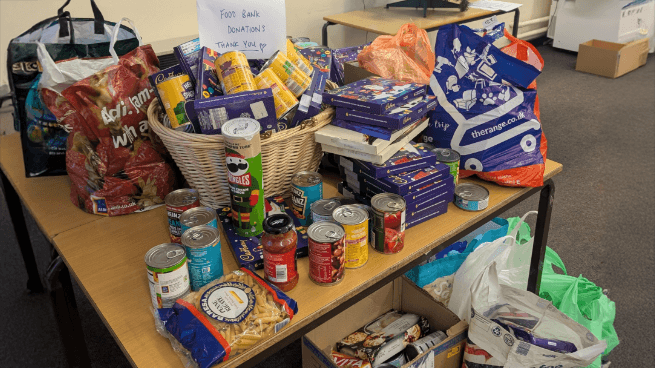 A photograph of the donations to the Sixth Form Food Bank Charity Event, circa December 2024.