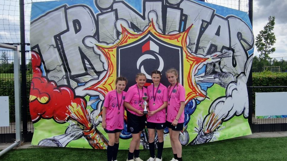 A photograph of students who won a trophy on a recent trip to Holland as part of the Hawarden FC girls team, circa June 2025
