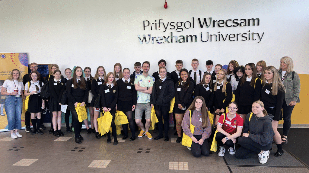 A photograph of students and staff who attended the Summer Festival of Welsh, hosted by the Coleg Cymraeg Cenedlaethol at Prifysgol Wrecsam’s Plas Coch Campus, circa July 2025