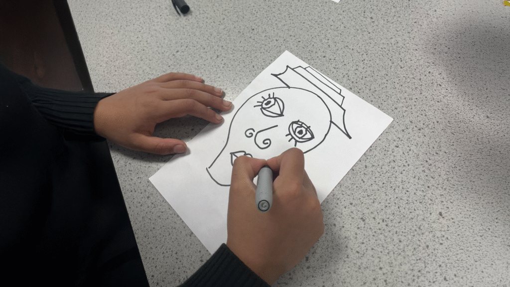 A photograph of an Art Club student drawing to celebrate Dyslexia Awareness Month, circa October 2025