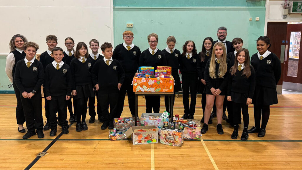 A photograph of Year 7 students who have collected food donations to share with the local community, circa October 2025