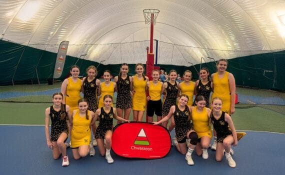 Students posing for a team photo at a netball event, wearing yellow and black kit, circa January 2026