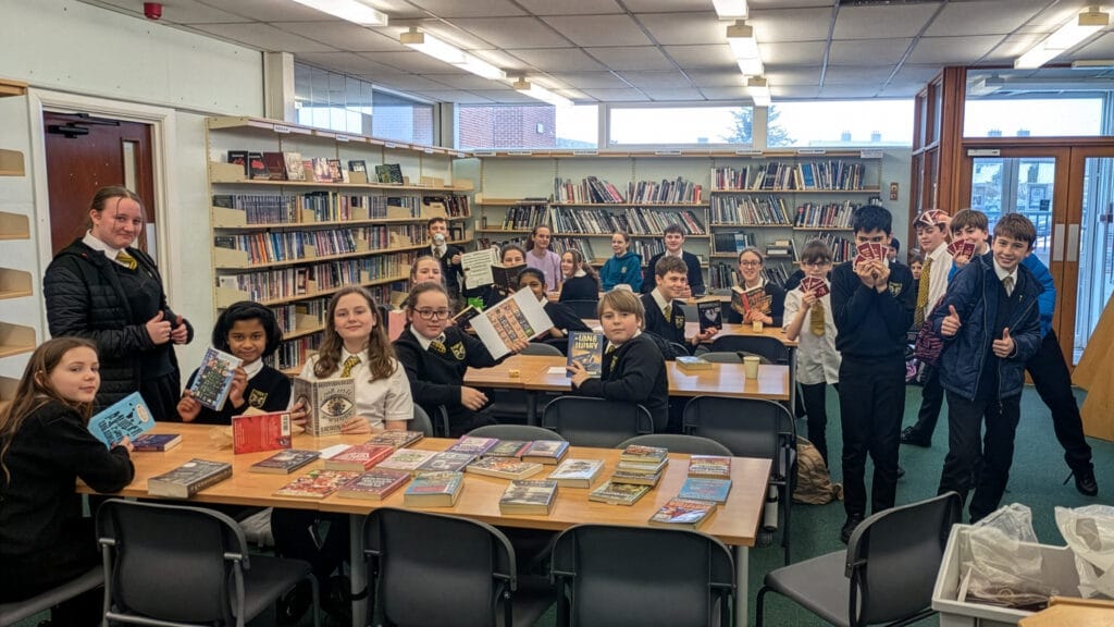 Students in the school library sharing and recommending books during a reading session, circa January 2026