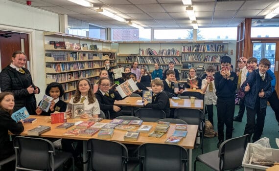 Students in the school library sharing and recommending books during a reading session, circa January 2026