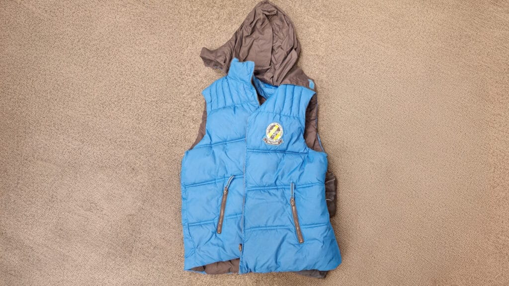 A blue and grey padded gilet laid out as part of the school?s lost property system, circa January 2026