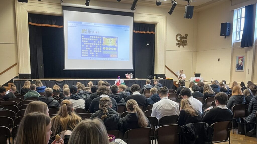 Students seated in the school hall watching a presentation on the big screen, circa March, 2026