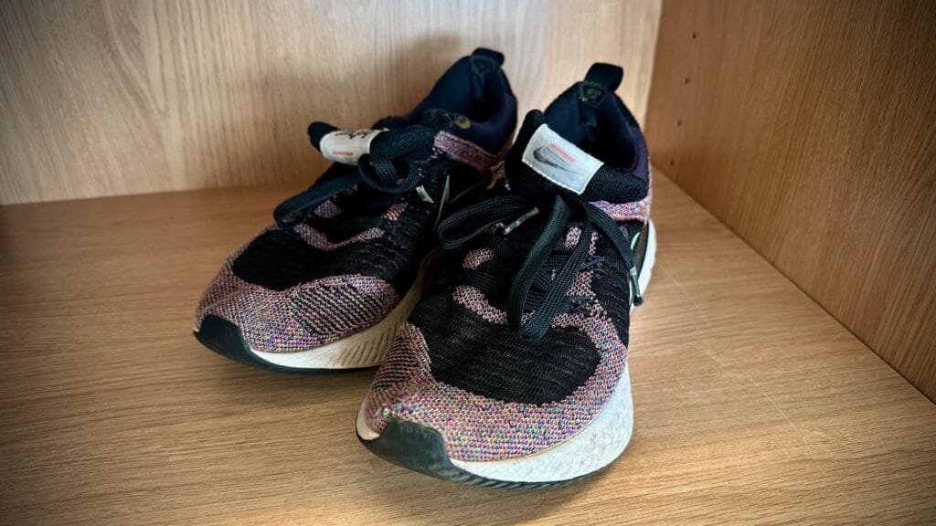 Pair of trainers displayed on a wooden shelf as part of a lost property photograph, circa March, 2026