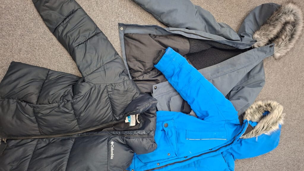Three coats laid out on the floor as part of the school’s lost property collection, circa March, 2026