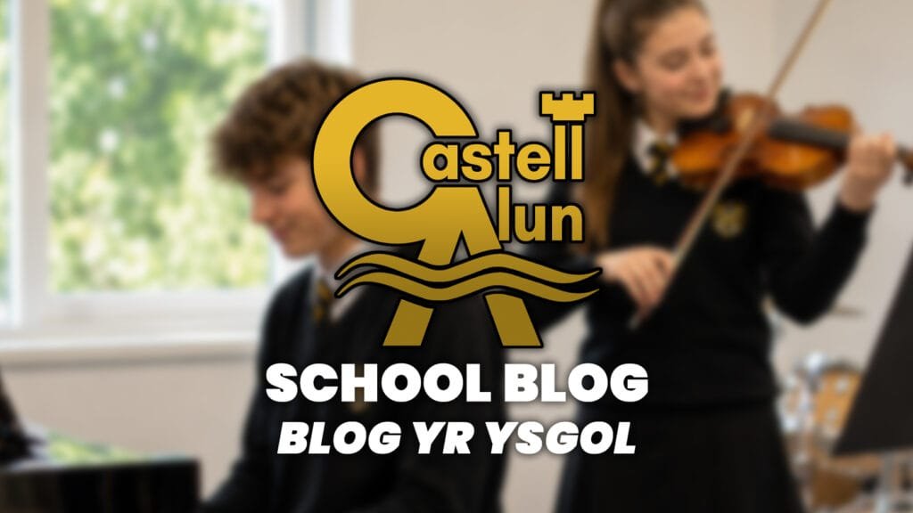 Promotional School Blog graphic showing a blurred music classroom scene with one student playing keyboard and another playing violin, overlaid with the Castell Alun logo and the text “School Blog” and “Blog yr Ysgol”.